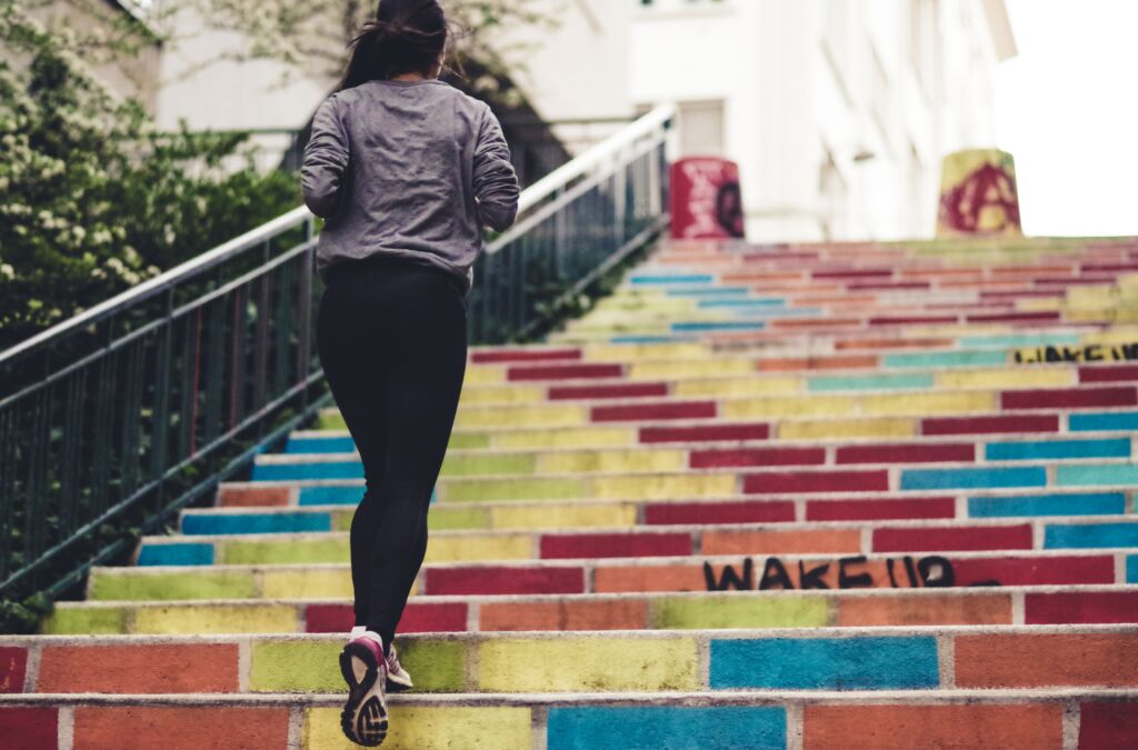woman running up a flight of stairs