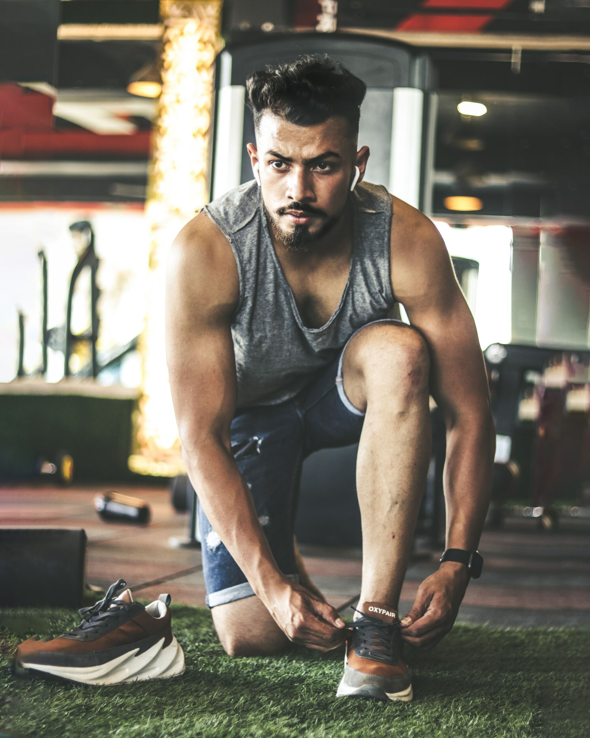man wearing a tank top getting ready for a workout. 