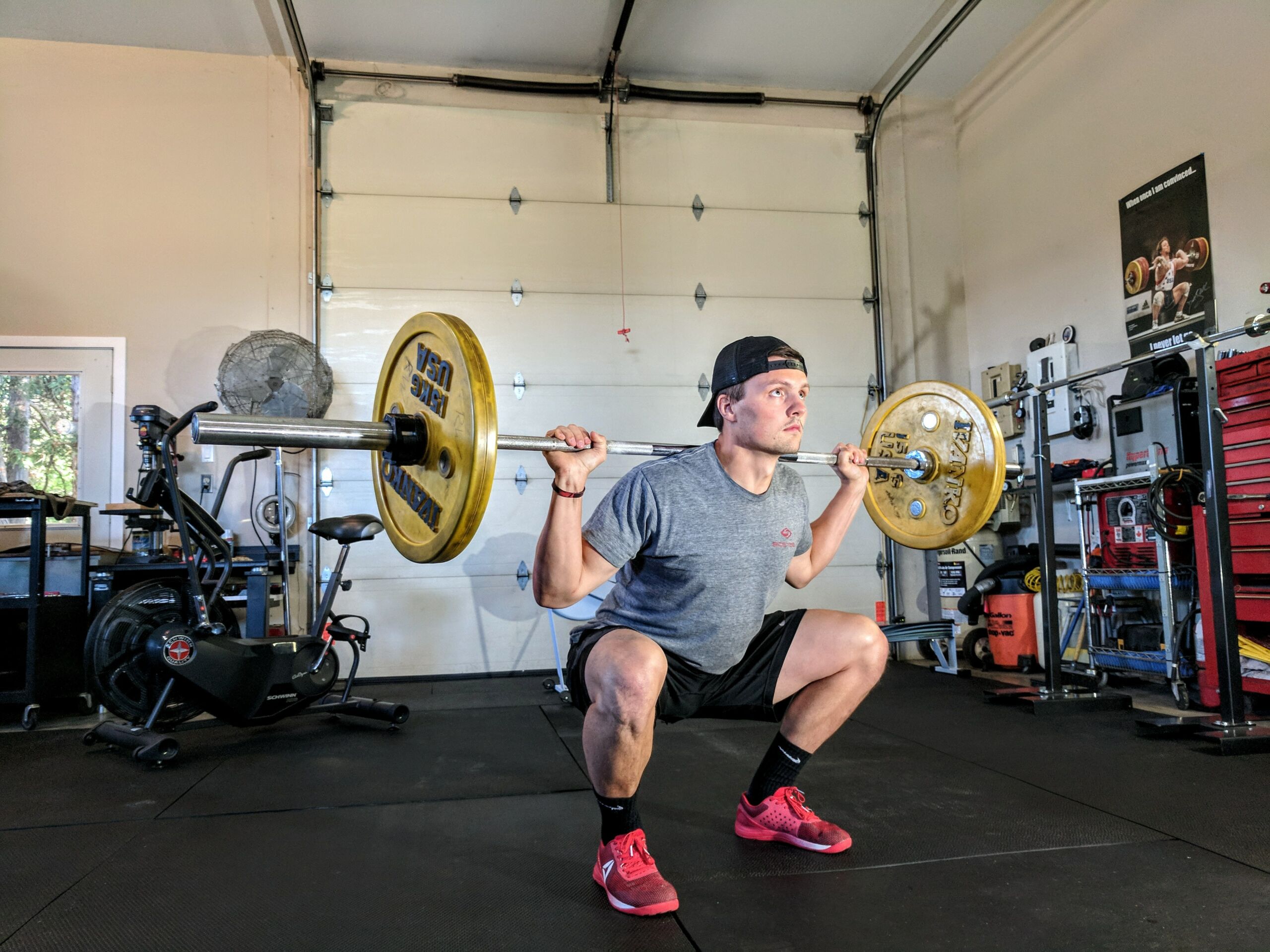 man preforming a barbell squat