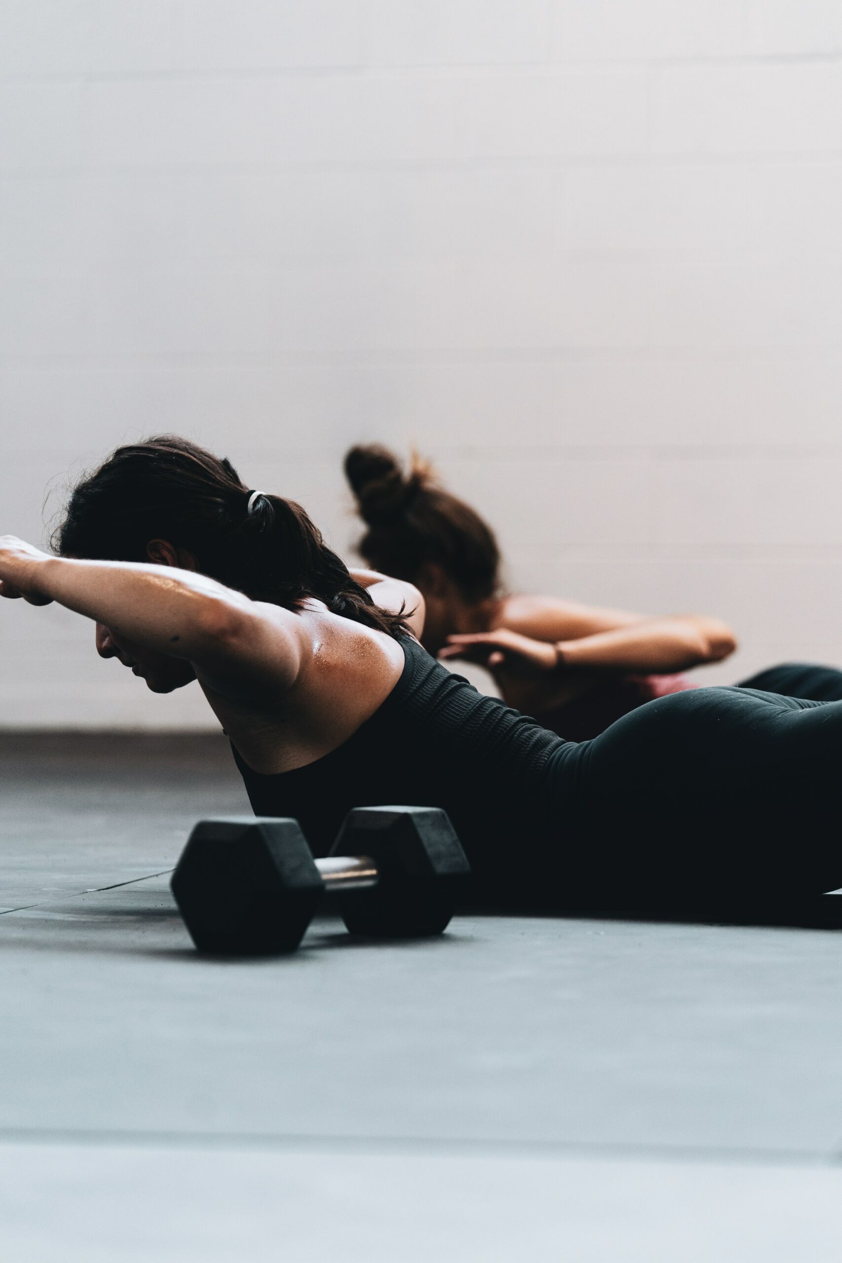 woman in black leggings laying on the ground